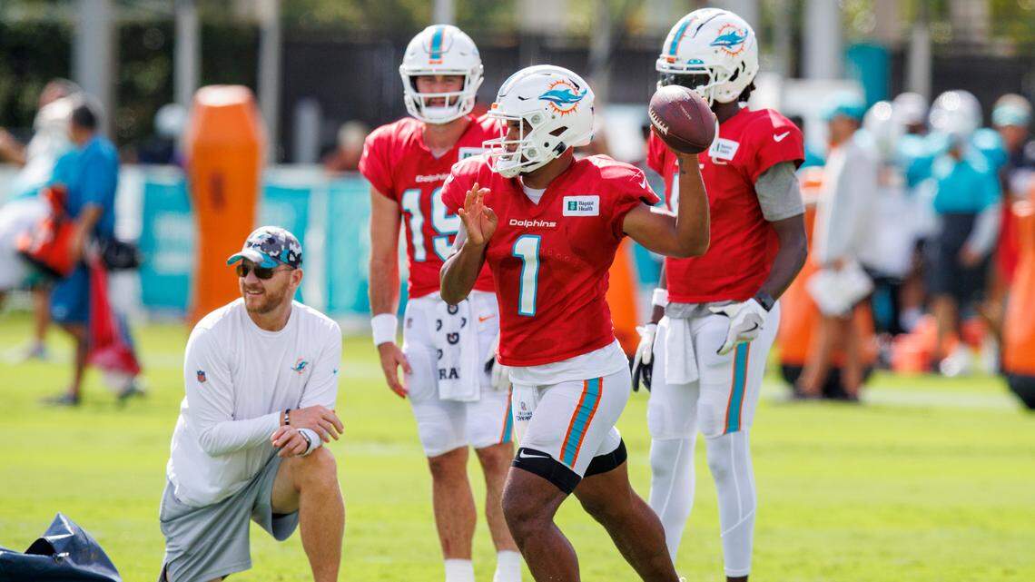 Miami Dolphins quarterbacks coach and passing game coordinator Darrell Bevell works with Dolphins quarterbacks Tua Tagovailoa (1) Teddy Bridgewater (5) and Skylar Thompson (19) during an NFL football training camp with the Philadelphia Eagles at Baptist Health Training Complex in Hard Rock Stadium on Wednesday, August 24, 2022 in Miami Gardens, Florida.