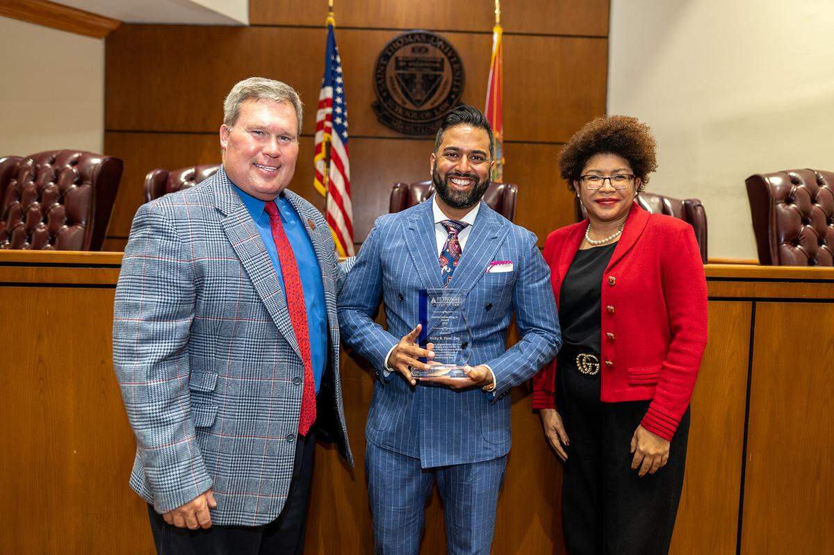 Ricky Patel, St. Thomas College of Law alumnus, received the inaugural Dr. Martin Luther King Jr. Award for his efforts in uplifting the Black community. From left: President of St. Thomas University David A. Armstrong, J.D.; MLK Award recipient Ricky Patel; Dean of College of Law Tamara F. Lawson.