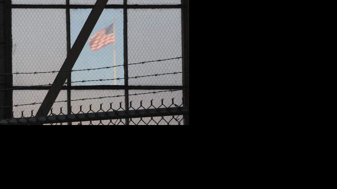 The flag as seen from the reporter's filing center as it flies over a war crimes courtroom at Camp Justice in this photo reviewed by the U.S. Department of Defense on October 17, 2012. The military forbids photography of the actual bunker-style eavesdropping proof courtroom where the security trials are held but permits images from the area, such as this one.