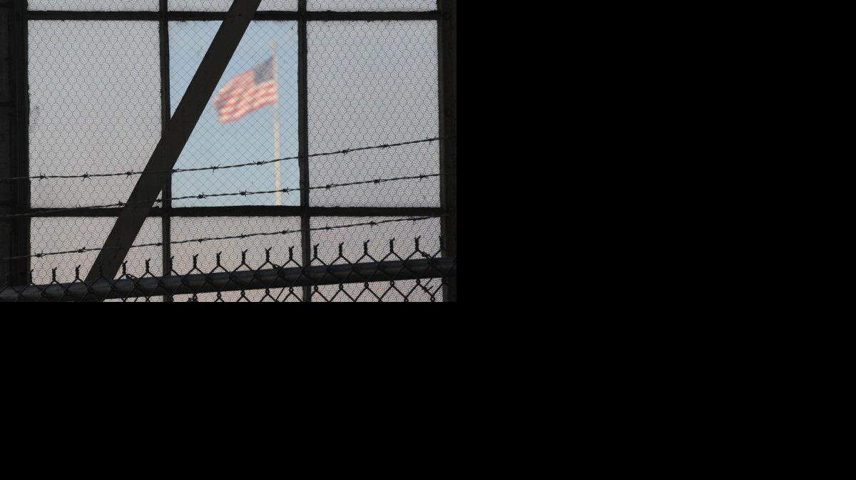 The flag as seen from the reporter's filing center as it flies over a war crimes courtroom at Camp Justice in this photo reviewed by the U.S. Department of Defense on October 17, 2012. The military forbids photography of the actual bunker-style eavesdropping proof courtroom where the security trials are held but permits images from the area, such as this one.