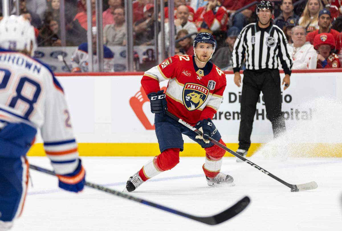Florida Panthers defenseman Gustav Forsling (42) looks to pass the puck as Edmonton Oilers right wing Connor Brown (28) defends in the first period of Game 5 of the NHL Stanley Cup Final at the Amerant Bank Arena on Tuesday, June 18, 2024, in Sunrise, Fla.