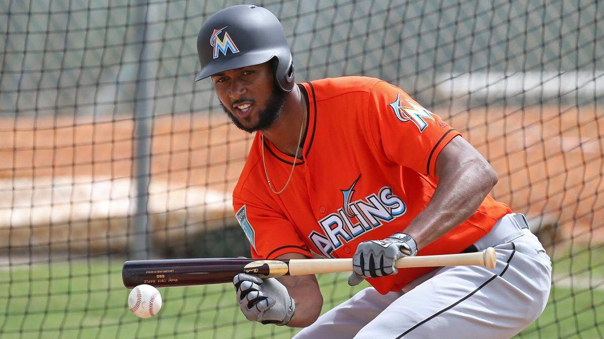 Miami Marlins pitcher Sandy Alcantara bunts during batting practice during spring training at Roger Dean Stadium in Jupiter.