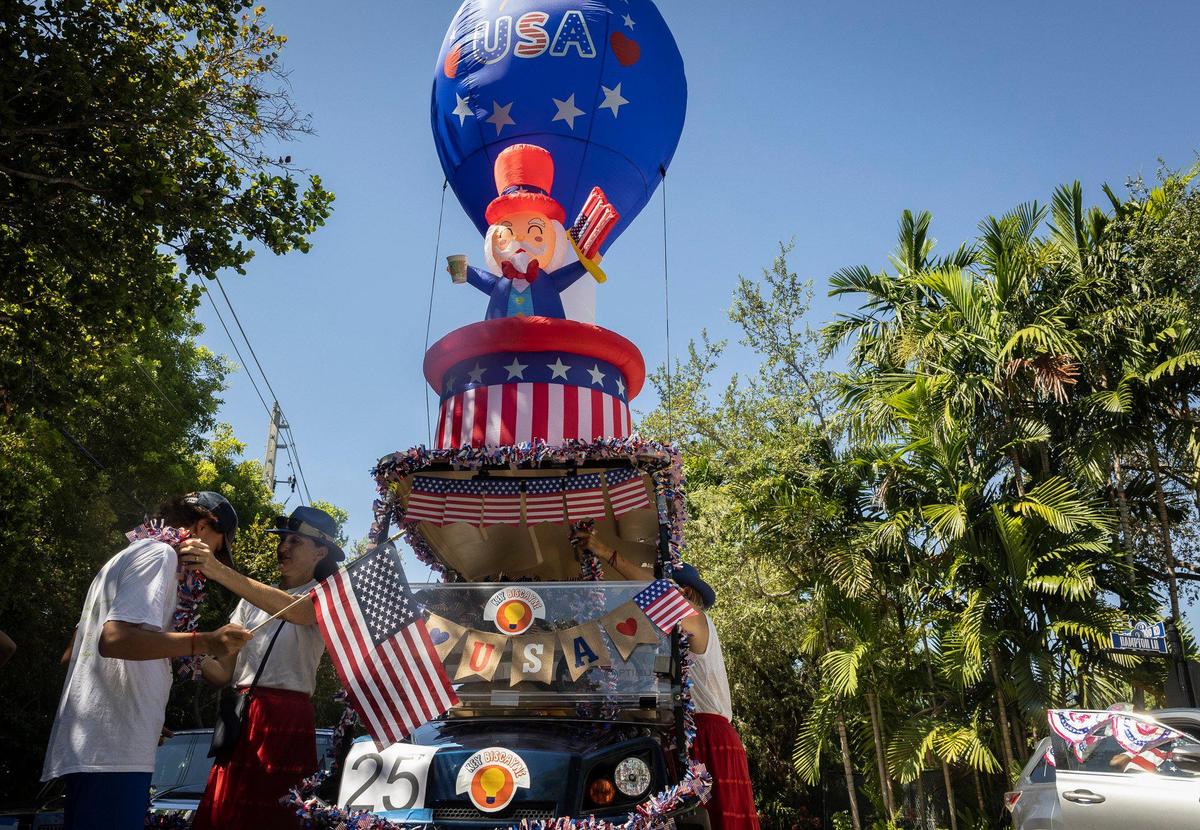 Members of the Key Biscayne Kids Marketplace group prepare a float before the Fourth of July parade along Crandon Boulevard in Key Biscayne.
