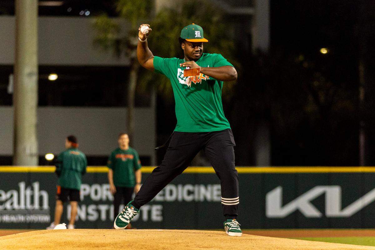 UM star defensive end Rueben Bain throws out the first pitch Friday in Miami baseball’s opening game against the Florida Gators at Mark Light Field on March 1, 2024.