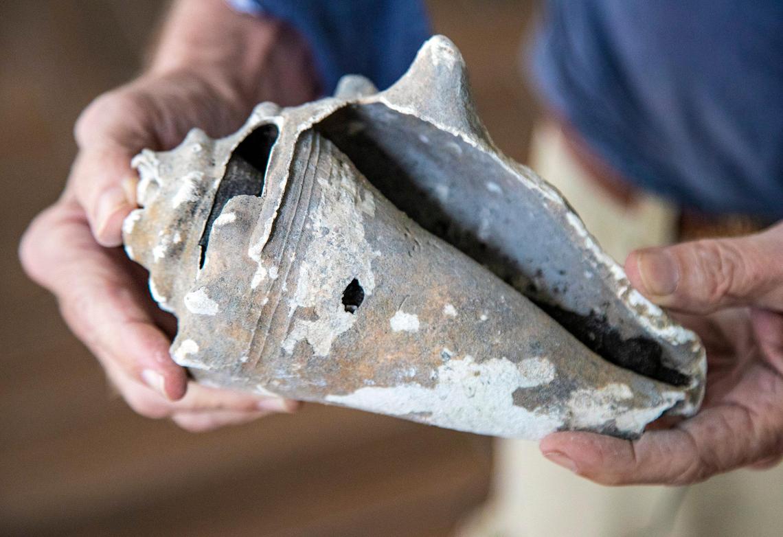 Archaeologist Bob Carr holds a conch shell, ancient food refuse from the Tequesta Indians.