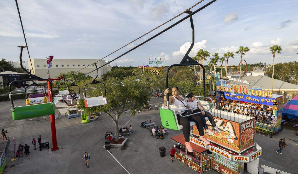 Guests ride a zip line during the opening day of the 74th annual Miami-Dade County Youth Fair on Thursday, March 12, 2026, in Miami, Fla.