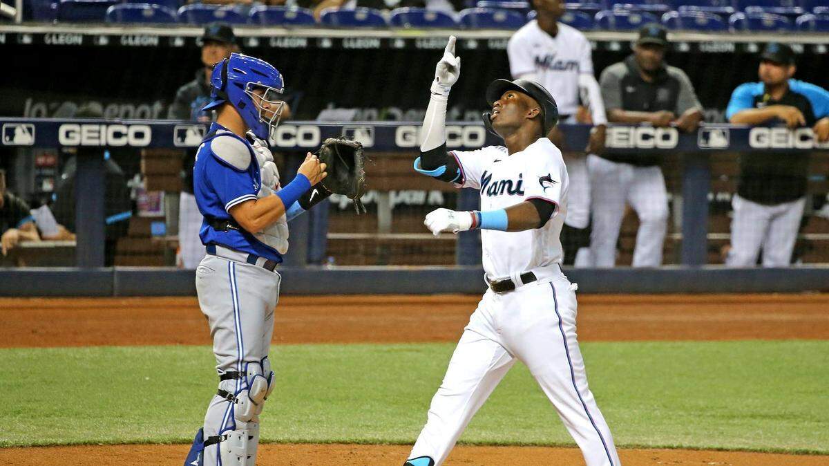 Miami Marlins Jesus Sanchez (76) crosses home plate after hitting a home run in the second inning as Toronto Blue Jays catcher Reese McGuire (7) watches at loandepot park in Miami, Florida, June 22, 2021.