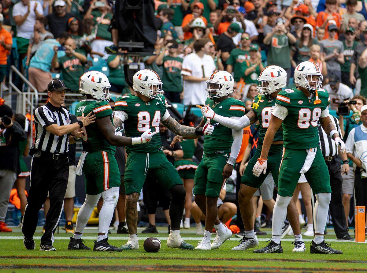 Miami Hurricanes tight end Cam McCormick (84) celebrates with teammates after scoring a touchdown during the first half of an ACC football game against the Duke Blue Devils at Hard Rock Stadium on Saturday, Nov. 2, 2024, in Miami Gardens, Fla.