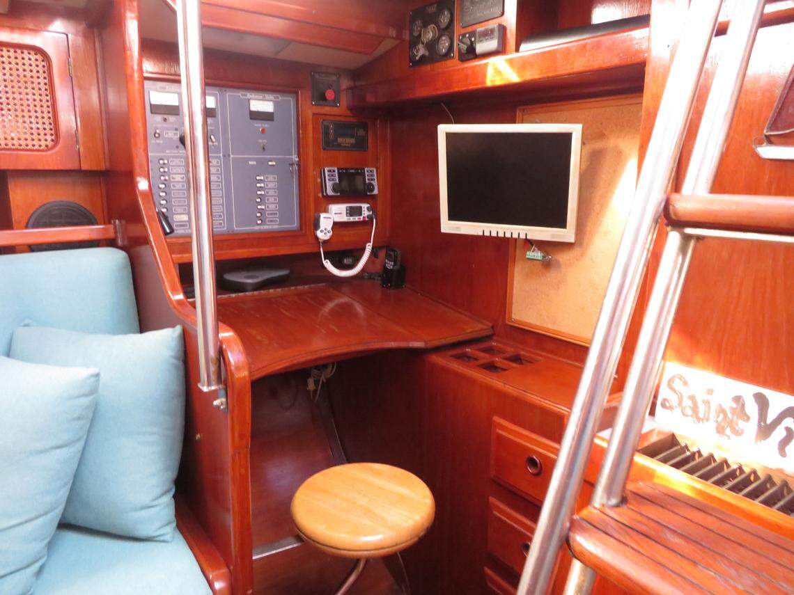 The captain’s controls are framed by varnished teak wood.