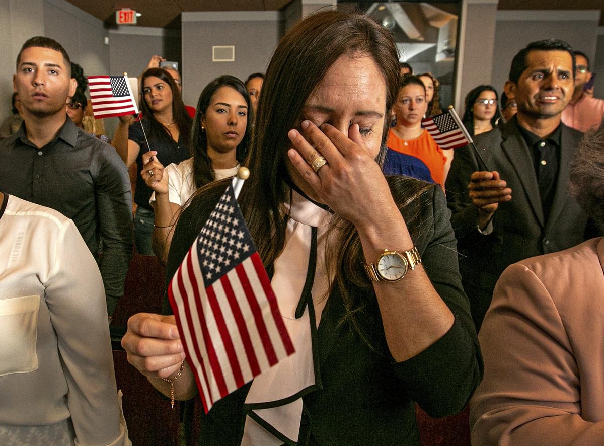 Ileana Gonzalez, of Cuba, holds back tears as U.S. Citizenship and Immigration Services administers the Oath of Allegiance to America’s newest citizens during a special naturalization ceremony at Everglades National Park on Wednesday, July 3, 2019.