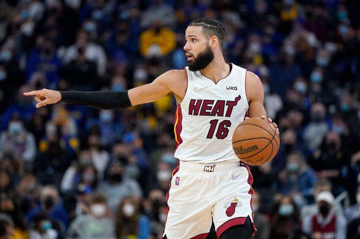 Miami Heat forward Caleb Martin (16) dribbles the ball up the court against the Golden State Warriors during the first half of an NBA basketball game in San Francisco, Monday, Jan. 3, 2022. (AP Photo/Jeff Chiu)