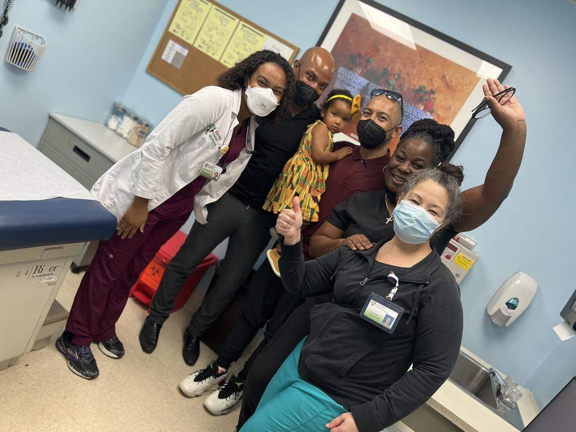 Dr. Hansel Tookes and his husband, Peter Ortega, pose with their daughter Paula and Jessie Trice staff members after Paula got her first dose of Moderna’s pediatric vaccine for kids under 5 on Wednesday, June 22, 2022.