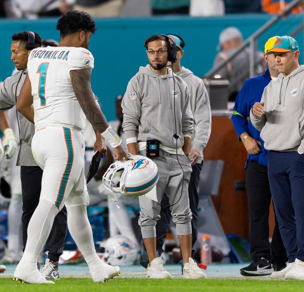 Miami Dolphins quarterback Tua Tagovailoa (1) walks off the field as head coach Mike McDaniel looks on in the fourth quarter of an NFL game against the Buffalo Bills at Hard Rock Stadium on Sunday, Jan. 7, 2023, in Miami Gardens Fla.