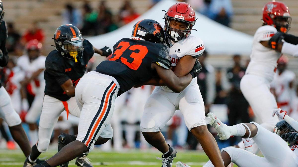 Booker T. Washington middle linebacker Tristan Ramsey (33) sacks Edison Red Raiders quarterback Kelvin Murray jr (7) during the second quarter of a high school football game at Traz Powell Stadium in Miami Florida, Monday, October 16, 2023.