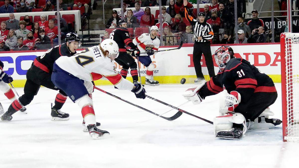 Florida Panthers right wing Owen Tippett (74) has his shot defended by Carolina Hurricanes center Martin Necas, left, and goaltender Frederik Andersen (31) during the first period of an NHL hockey game Wednesday, Feb. 16, 2022, in Raleigh, N.C. (AP Photo/Chris Seward)