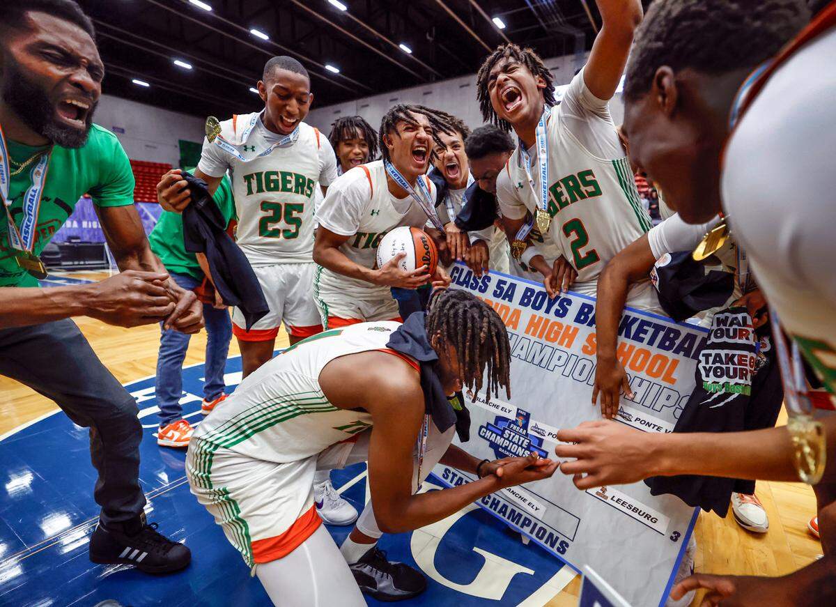 Blanche Ely Tigers celebrate on the court placing the school name on the final playoff bracket after defeating Ponte Vedra in the FHSAA Class 5A Final for Boys High School Basketball State Championship.