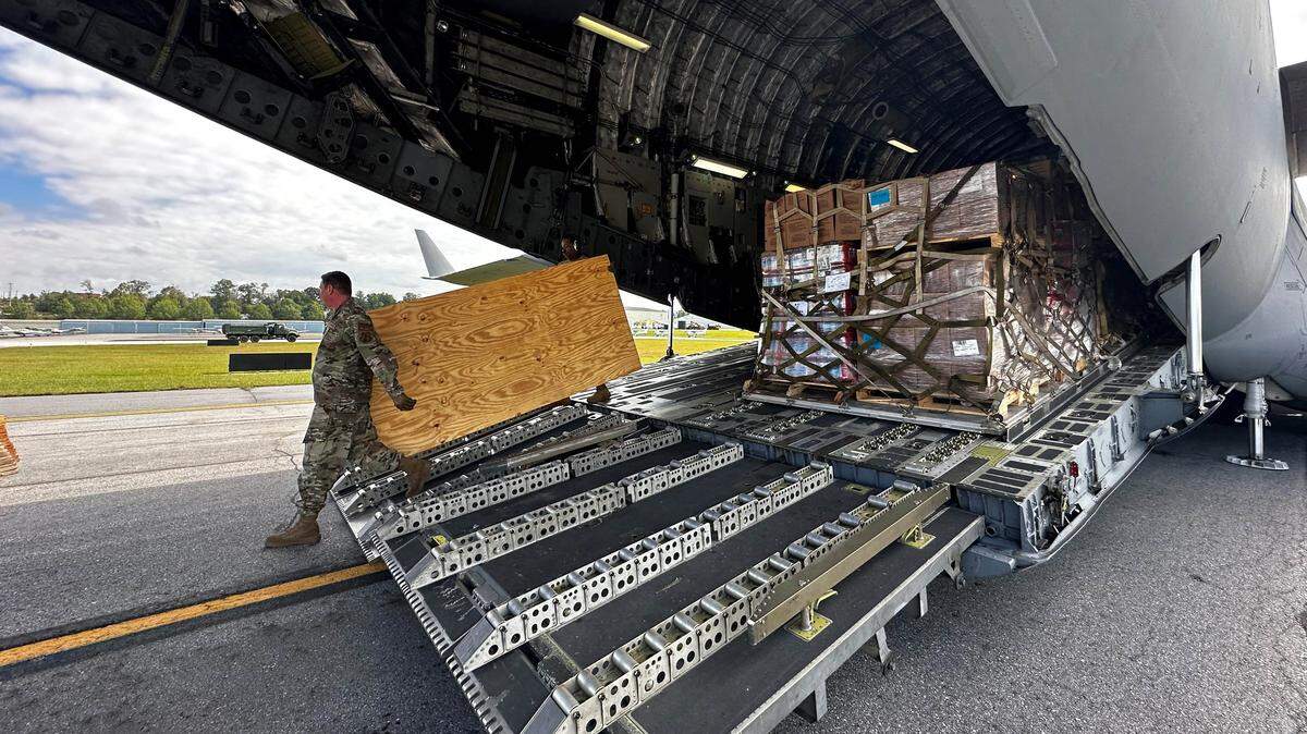 Asheville, NC (Sept. 30, 2024) - National Air Guard unloads supply like food and water from a C-17 aircraft for distribution to survivors after Hurricane Helene.