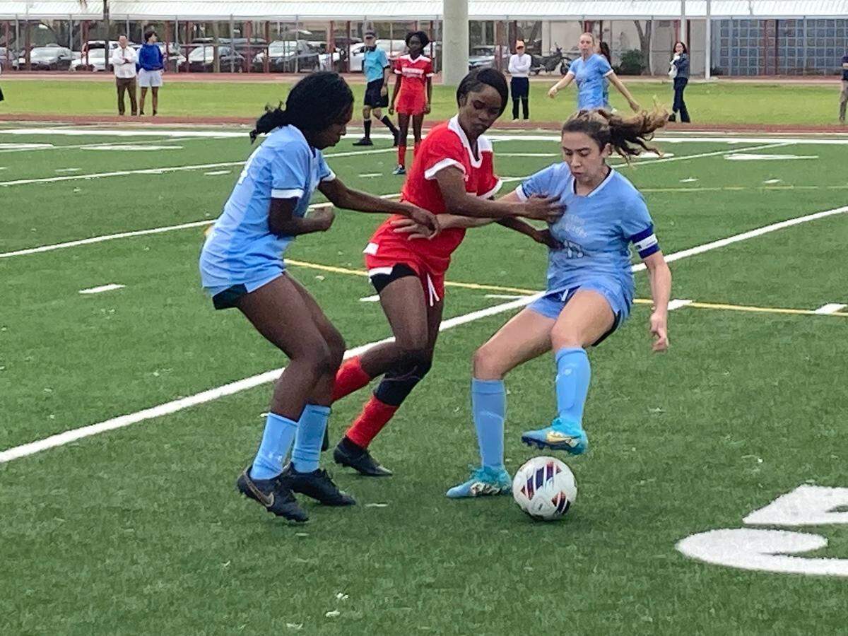 Edison’s Shnidine Marcialus battles for possession with a pair of Ransom defenders during Friday’s Region 4-3A girls’ soccer semifinal victory at Miami Edison.