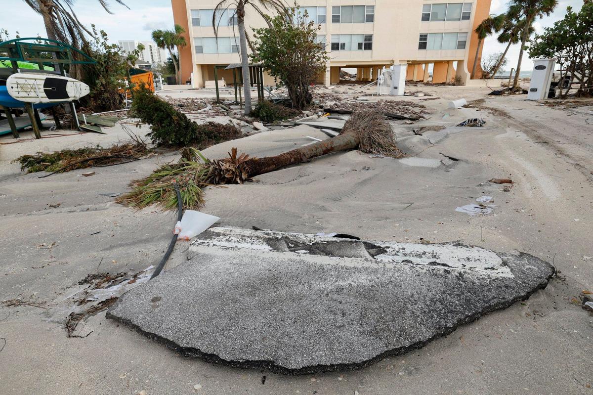 A washed out road caused by storm surge from hurricanes Helene and Milton is seen at Fisherman’s Cove beach front condominium rentals on Siesta Key, Florida on Thursday, October 10, 2024.