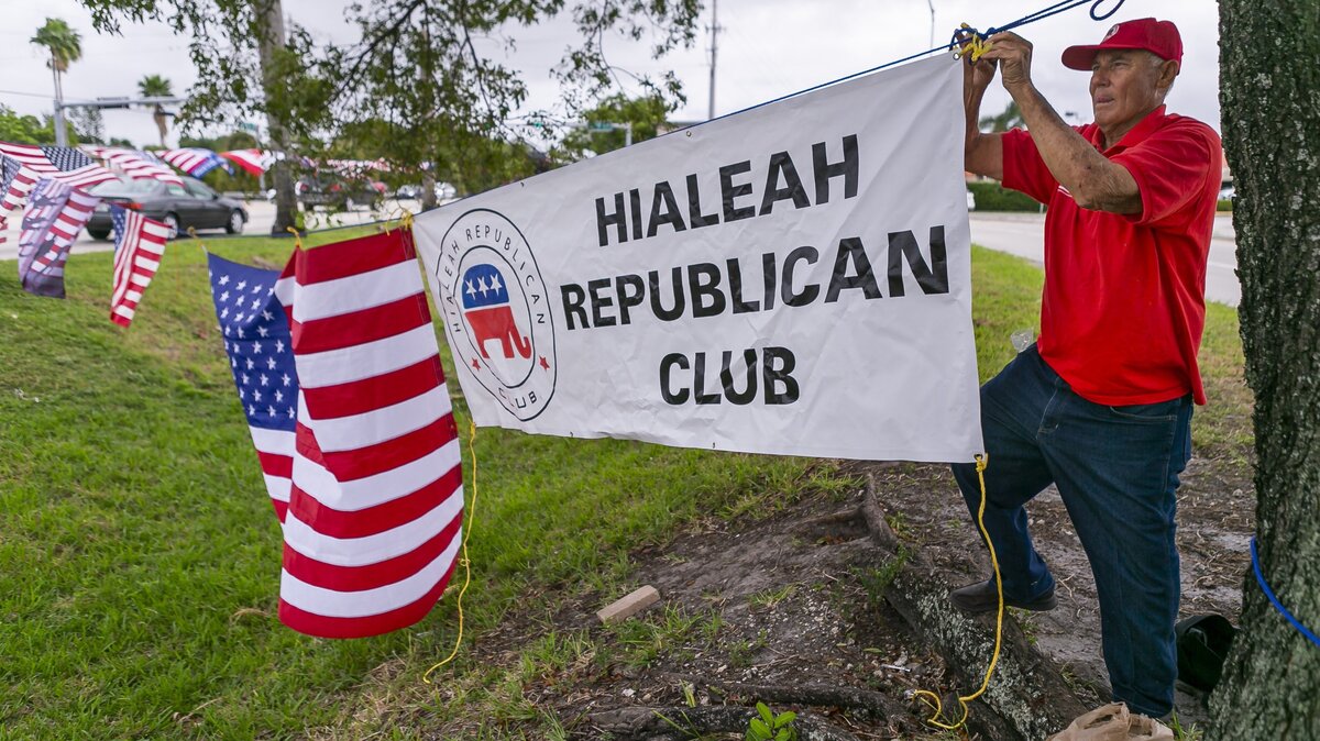 Diosdado Suarez, 80, hangs flags during a Hialeah Republican Club meetup in Hialeah off the Palmetto Expressway and 68th Street on Saturday, November 9, 2019. Suarez is a member of the club and hopes to help President Trump get reelected in 2020.