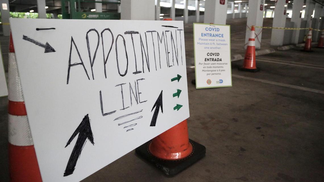 Signs at the Caleb Center garage direct people where to go to get tested for COVID-19.