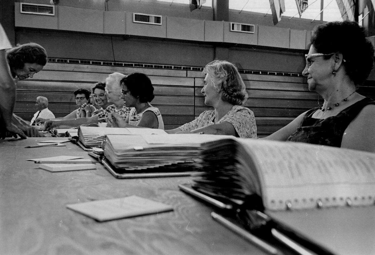 North Miami precinct workers at the Armory as voters line up in 1964.