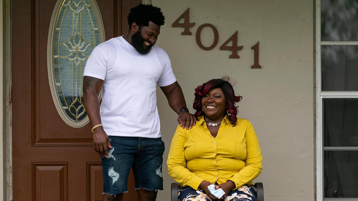 Donna Hester, 59, laughs with her son, Malcolm Davis, 37, outside of her home in Miami Gardens on May 16. A local ER doctor and a few other donors gave Hester a brand new air-conditioning unit after reading a story about her in the Miami Herald.
