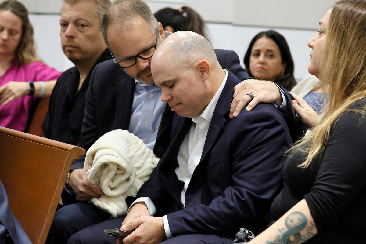 Ryan Petty comforts Ilan Alhadeff as they await the verdict in the trial of Marjory Stoneman Douglas High School shooter Nikolas Cruz at the Broward County Courthouse in Fort Lauderdale on Thursday, Oct. 13, 2022. Petty’s daughter, Alaina, and Alhadeff’s daughter, Alyssa, were killed in the 2018 shootings. Cruz pleaded guilty to 17 counts of premeditated murder in the 2018 shootings.