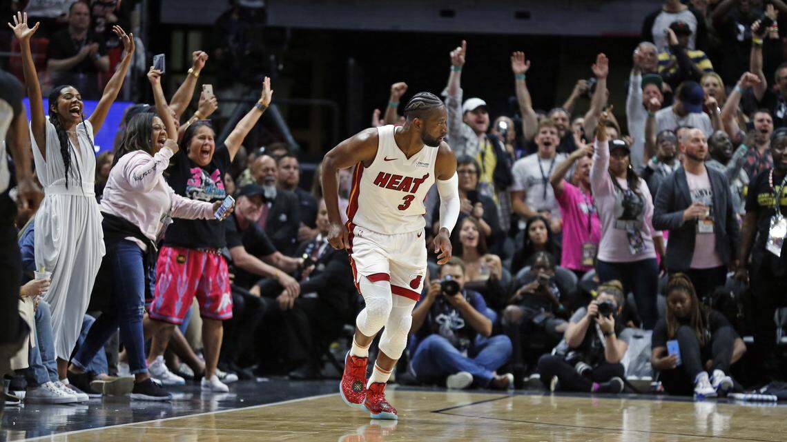 Miami Heat fans cheer Miami Heat guard Dwyane Wade (3) in the fourth quarter as the Miami Heat host the Philadelphia 76ers at the AmericanAirlines Arena in Miami on Tuesday, April 9, 2019.