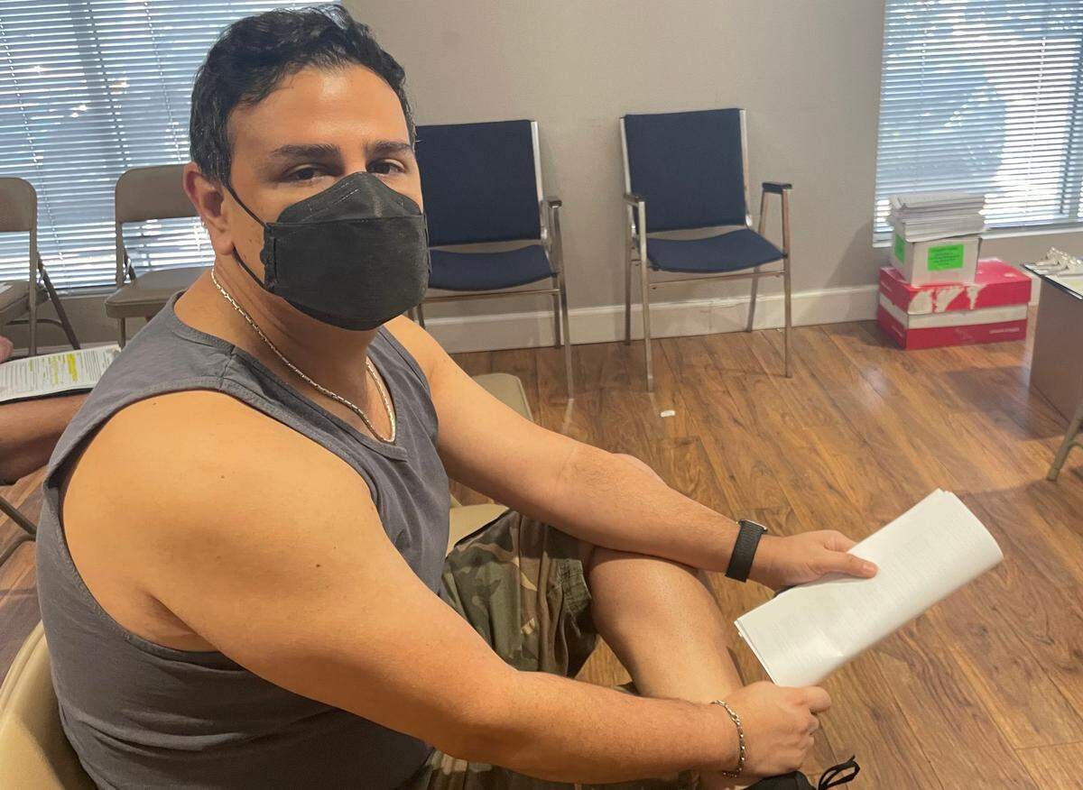 Elias Taravay, 49, waits for the 15-minute observation period after receiving the monkeypox vaccine at the Pride Center at Equality Park in Wilton Manors, Florida, on Tuesday, July 19, 2022.