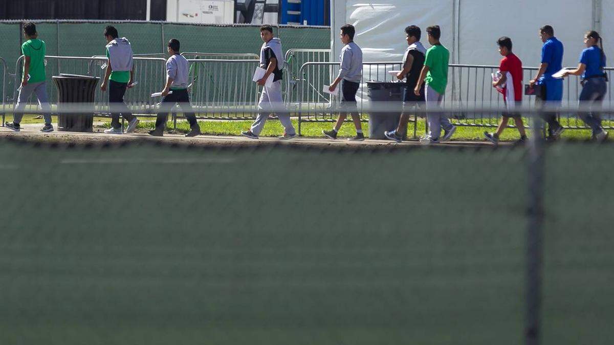 Children walk through the Homestead Temporary Shelter for Unaccompanied Migrant Children in Homestead, Florida.