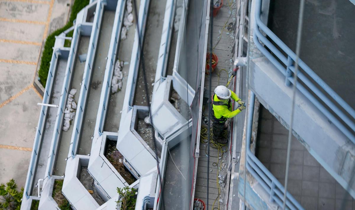 A construction employee works to renovate the Hamilton on the Bay in Miami’s Edgewater neighborhood on Tuesday, June 8, 2021. New renovations involve gutting all existing units and improving common areas to make the property more competitive with newer buildings.