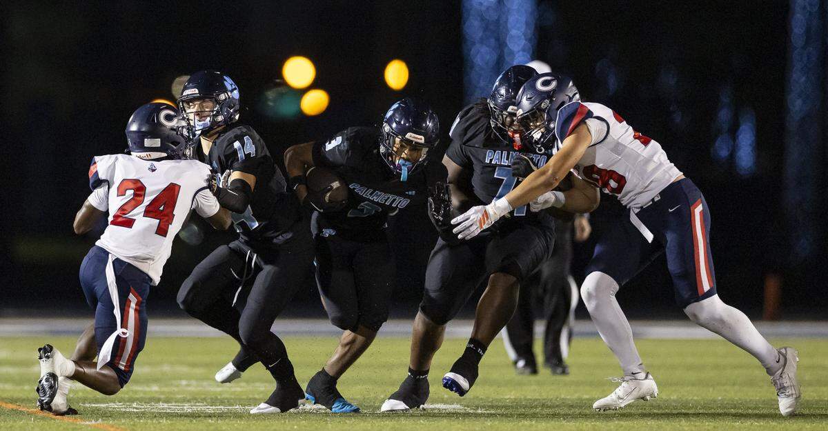 Palmetto Panthers defensive back Green Braylen (3) runs with the ball in the first half of his Region 4-7A quarterfinal high school football playoff game against the Columbus Explorers at Tropical Park on Friday, Nov. 21, 2025, in Miami, Fla.