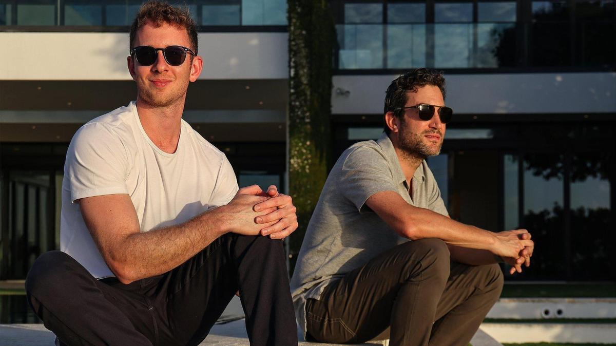 Jon Oringer, founder of photo platform Shutterstock, right, and his partner Edward Lando, left, are hoping to transform the tech scene in Miami, where Oringer recently bought a home. They plan to launch companies they hope will ‘improve the human condition’ — or at least fix a problem. And they plan to hire locally: Oringer says over 5 to 10 years   he hopes to create thousands of jobs for the region. They are shown at Oringer’s Miami Beach home on  Dec.  31, 2020.