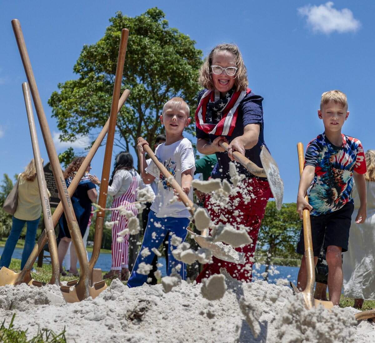 Yonah Janowitz, center, a direct descendant of American Revolution patriots, and her sons David, left, and Marcus Janowitz, right, toss sand over the 2026 time capsule during a ceremony celebrating America's 250th anniversary at Tropical Park on Monday, June 29, 2026, in Miami-Dade County. Miami-Dade County marked America's 250th anniversary with a time capsule installation and America 250 Patriot Marker unveiling ceremony on Monday, June 29, 2026, at Tropical Park in Miami-Dade. The event celebrated the nation's history and aimed to preserve the present for future generations. The Miami-Dade 250 time capsule will remain sealed for 50 years, to be opened at the tricentennial in 2076, preserving the stories, achievements and cultural spirit of the community.
