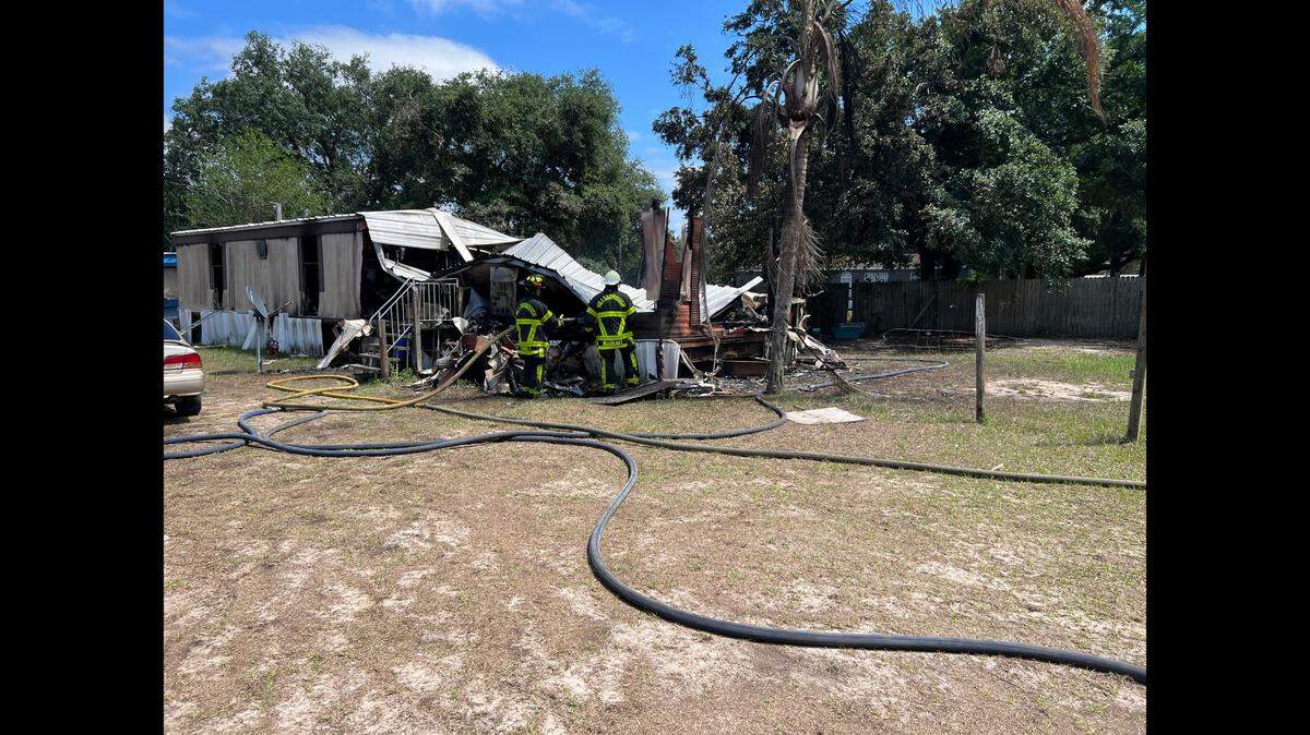 A mother of three suffered burns while trying to save her husband and two of her children from a house fire in Hillsborough County, Florida, officials say.