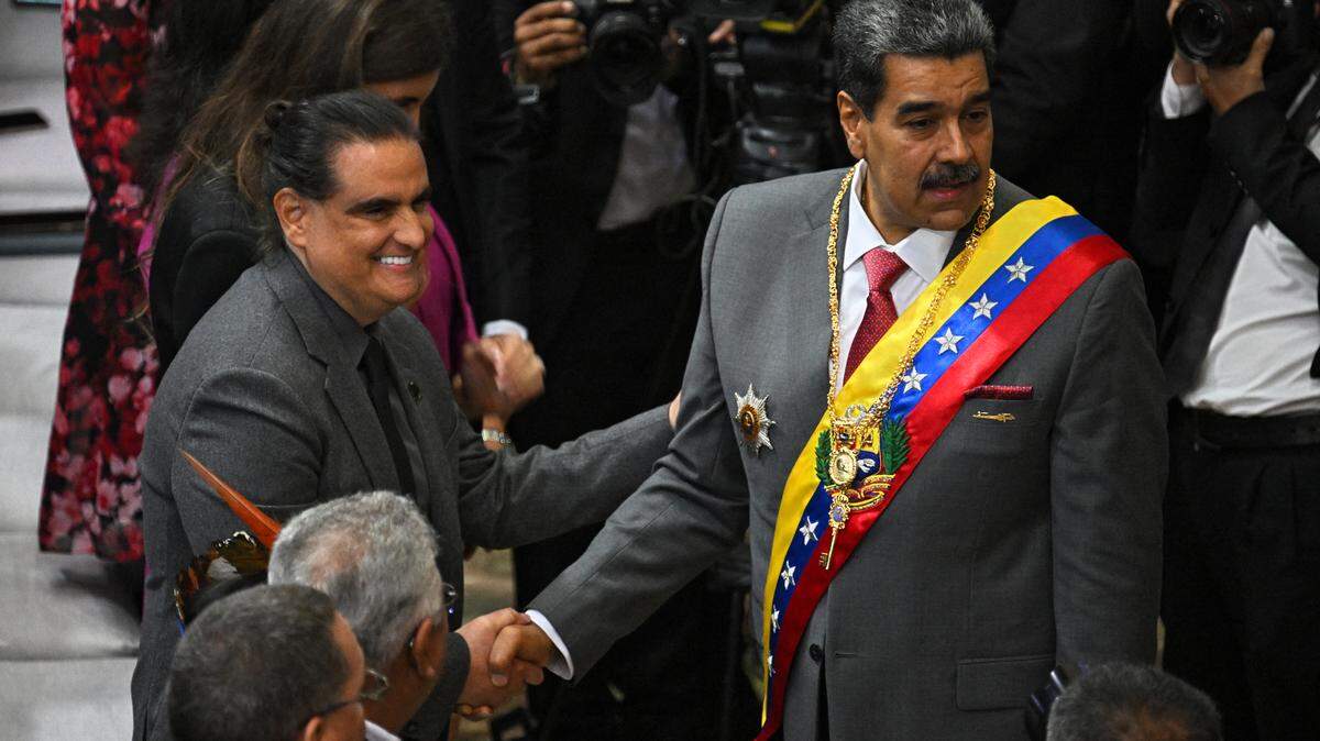 In this file photo, Venezuelan leader Nicolas Maduro (R) shakes hands with Colombian-born businessman Alex Saab upon arriving at the National Assembly headquarters to give his state of the nation address to parliament, in Caracas on Jan. 15, 2024.