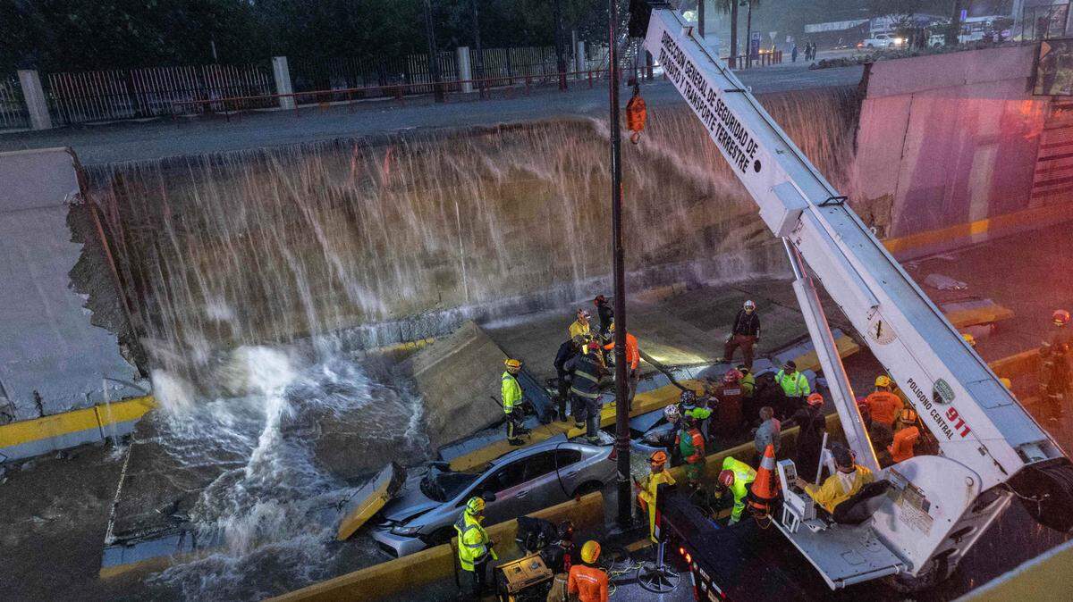 Rescue teams work at the place where a wall collapsed at the entrance of a tunnel in Santo Domingo, Dominican Republic, Saturday, Nov. 18, 2023. According to Civil Defense at least 9 people were killed when the wall fell down due to heavy rains.