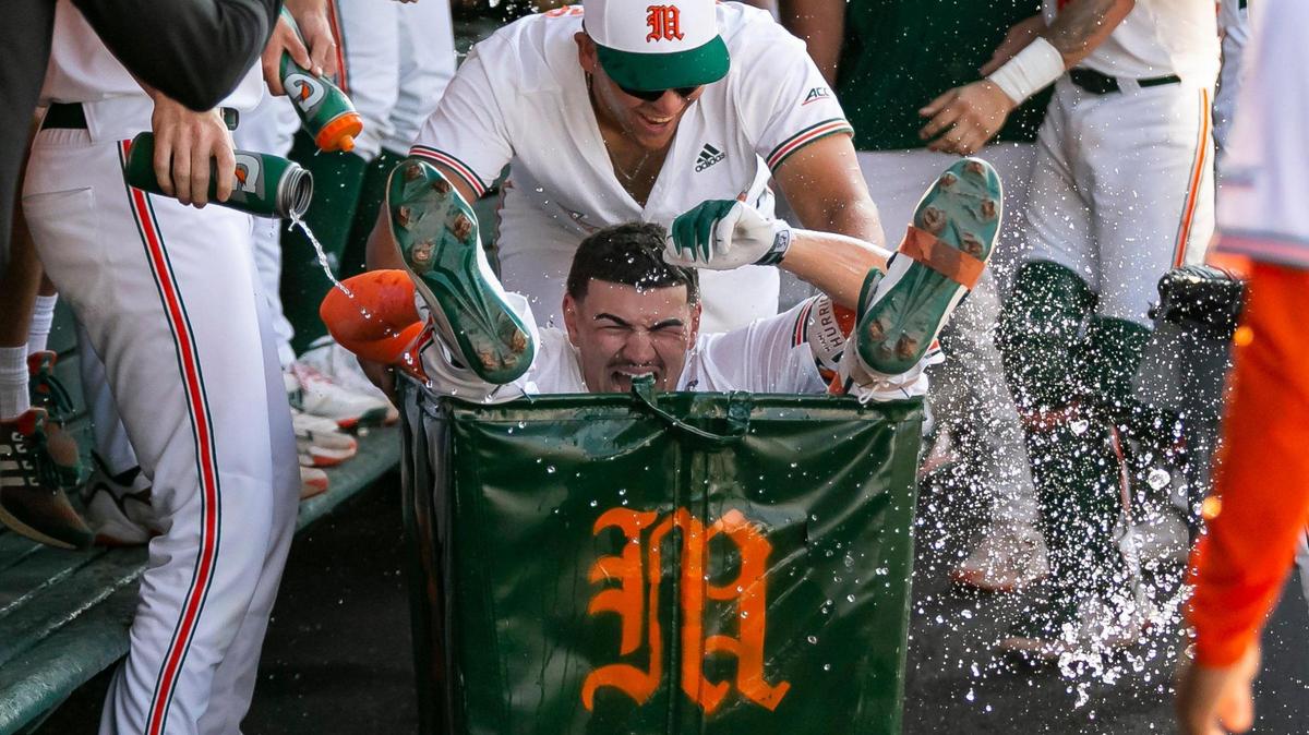 Miami Hurricanes infielder Jason Torres (37) celebrates with pitcher Alejandro Torres (49) after scoring a home run against Dartmouth during the seventh inning of a NCAA baseball game at Alex Rodriguez Park at Mark Light Field on Sunday, Feb. 26, 2023, in Coral Gables, Fla.