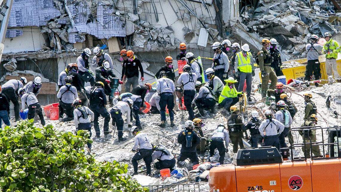 Rescuers are seen on the rubble on Friday, July 2, 2021, as the search and rescue mission continues at the Champlain Towers South site, nine days after the building collapsed.