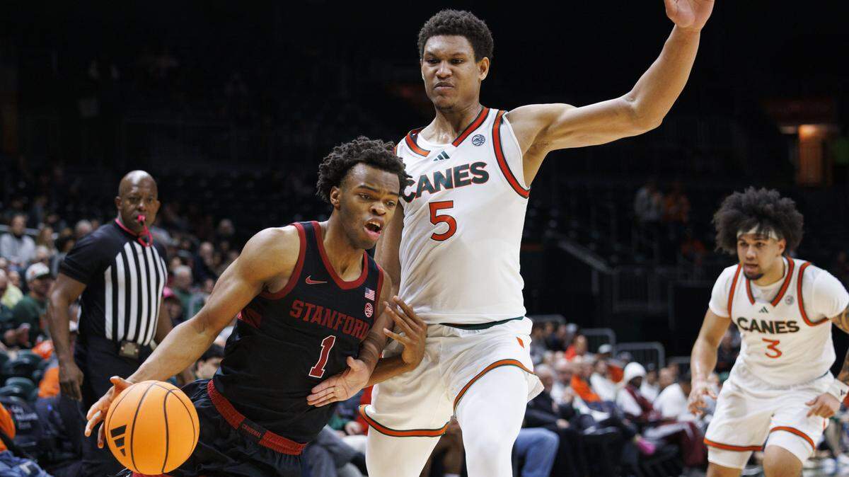 Stanford Cardinal guard Ebuka Okorie (1) drives padded Miami Hurricanes forward Malik Reneau (5) during the second half of a game on Wednesday, Jan. 28, 2026, at Watsco Center in Coral Gables, Fla. The Miami Hurricanes won 79-70.