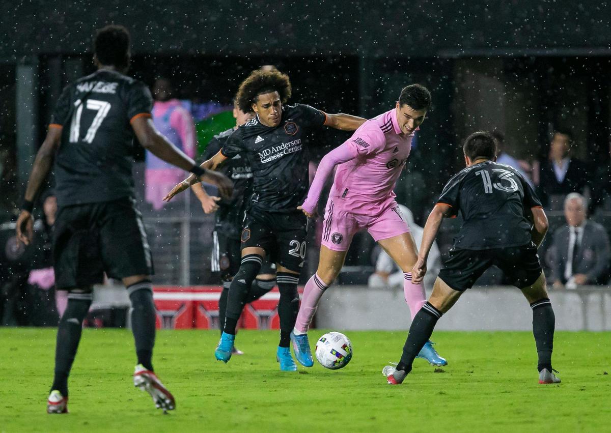 Inter Miami forward Robbie Robinson (19) fights to get past Houston Dynamo defender Ethan Bartlow (13) during the second half of their MLS soccer match at DRV PNK Stadium on Saturday, April 2, 2022, in Fort Lauderdale, Florida.