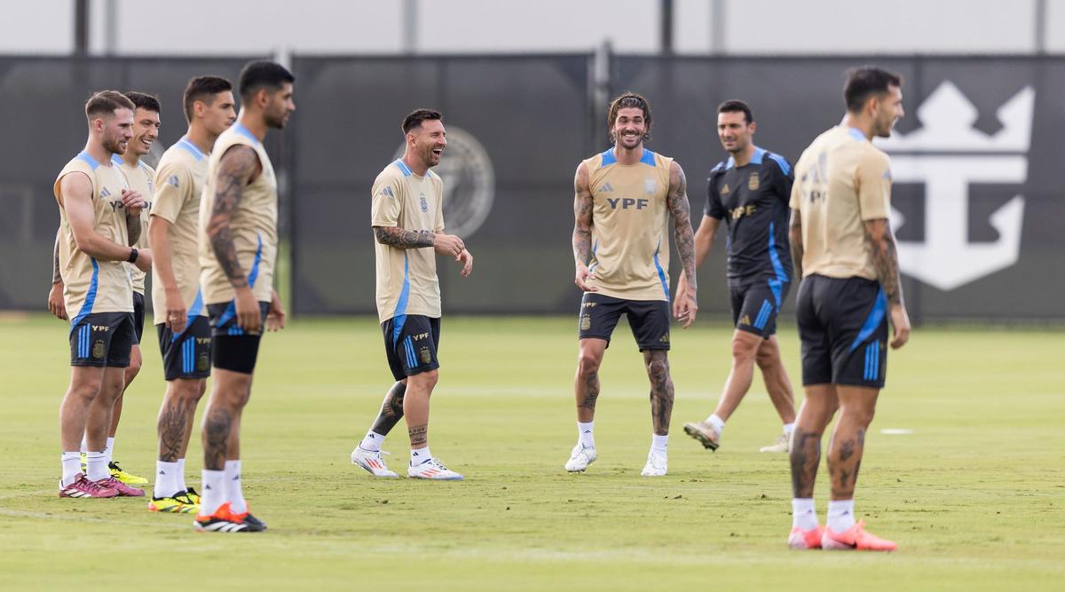 Argentina’s forward Lionel Messi, center, laughs with his teammates at the Florida Blue Training Center.
