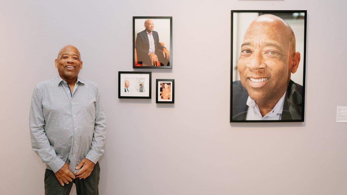 Darrel Burks stands in front of his portraits at the “Give Them Their Flowers” exhibit. He was one of the oral history participants who talked about being Black and gay in Miami.