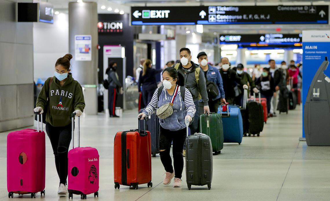 Cruise crew members line up to check in for charter flights at Miami International Airport after disembarking at PortMiami on Wednesday, April 1, 2020, as cruise ship travel is suspended due to the coronavirus outbreak.