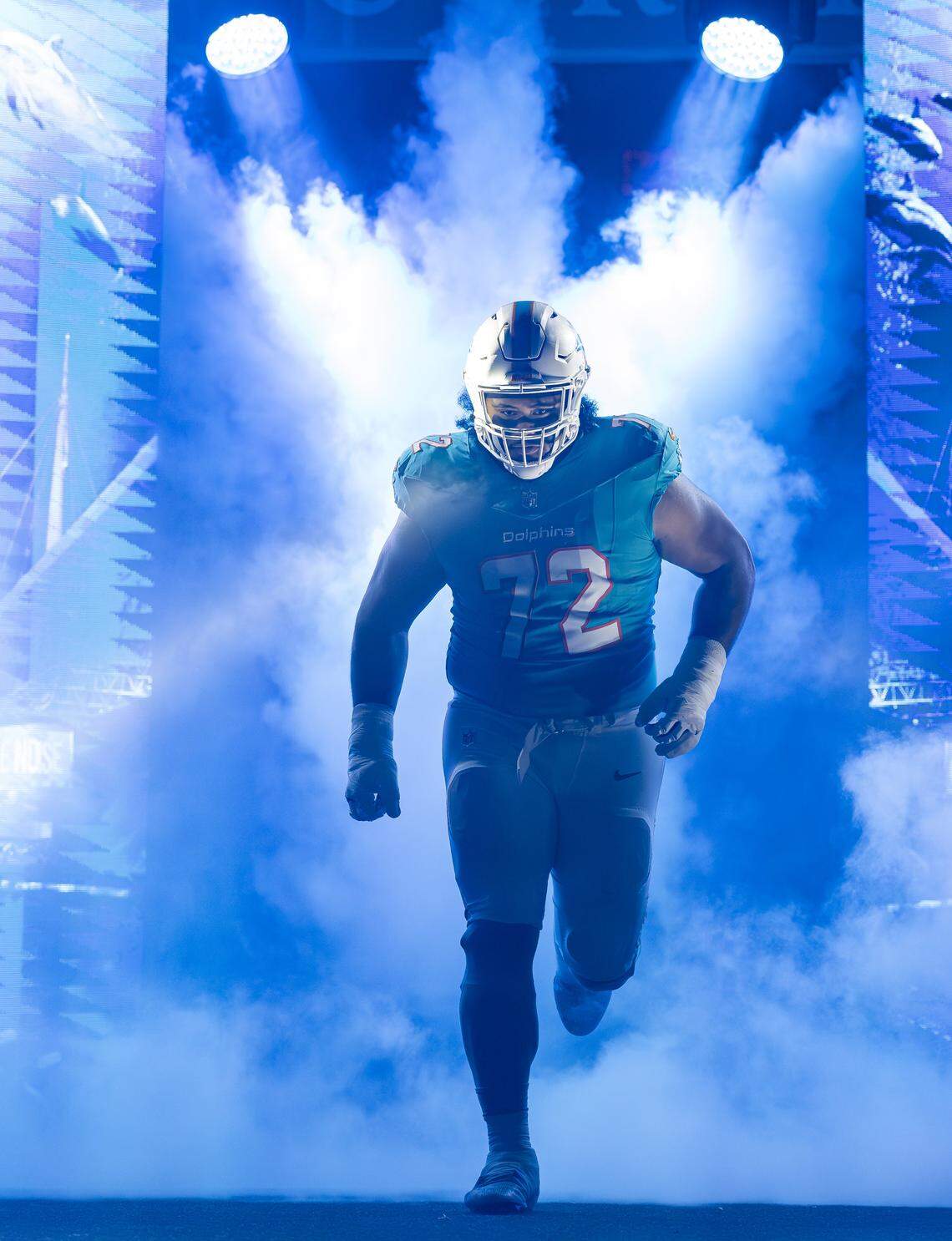 Miami Dolphins guard Jonah Savaiinaea (72) runs onto the field before the start of his NFL game against the Baltimore Ravens at Hard Rock Stadium on Thursday, Oct. 30, 2025, in Miami Gardens, Fla.
