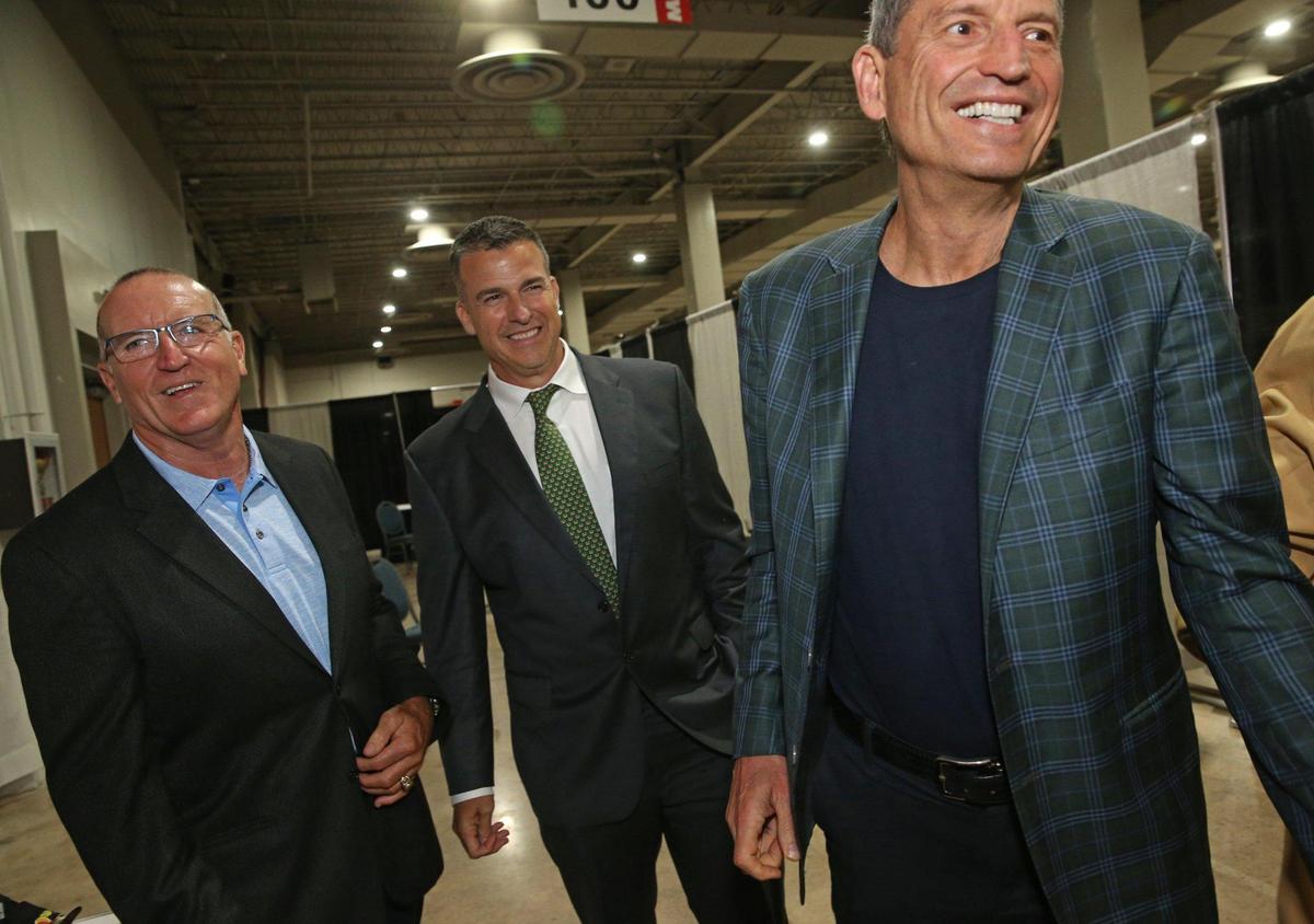 Former Hurricanes football players Juan Comandeiro, Mario Cristobal, and Bernie Kosar, left to right, arrive for the University of Miami Sports Hall of Fame Induction Banquet at the Doubletree by Hilton Miami Airport ConventionCenter in Miami, Florida on Thursday, April 21, 2022. Cristobal is now head coach of the Miami Hurricanes.