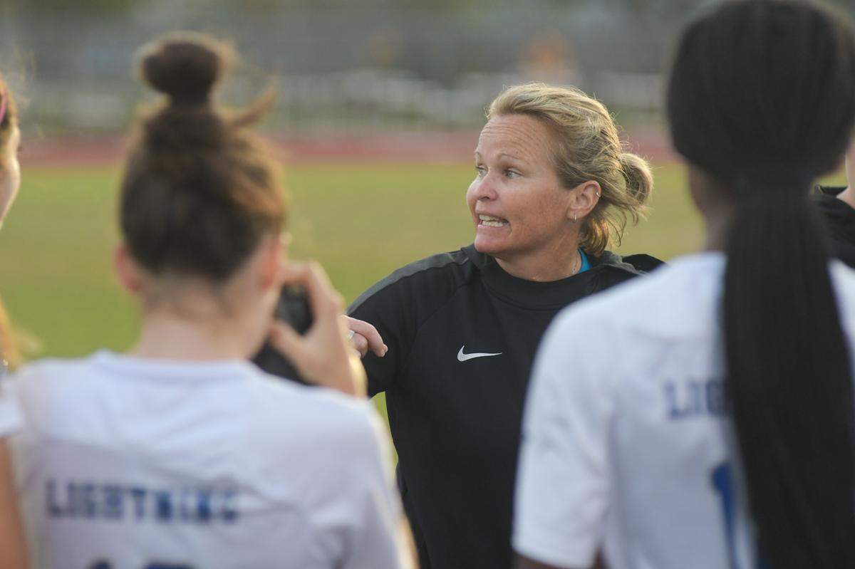 Cypress Bay girls’ soccer coach Kate Dwyer talks to her team in the first half of Cypress Bay’s regional semifinal win over Stoneman Douglas on Friday, Feb. 11, 2011, at Stoneman Douglas High in Parkland, Florida.