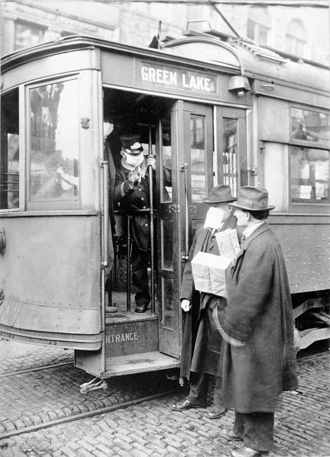 A Seattle street car conductor refuses to allow passengers on board who are not wearing masks in 1918.