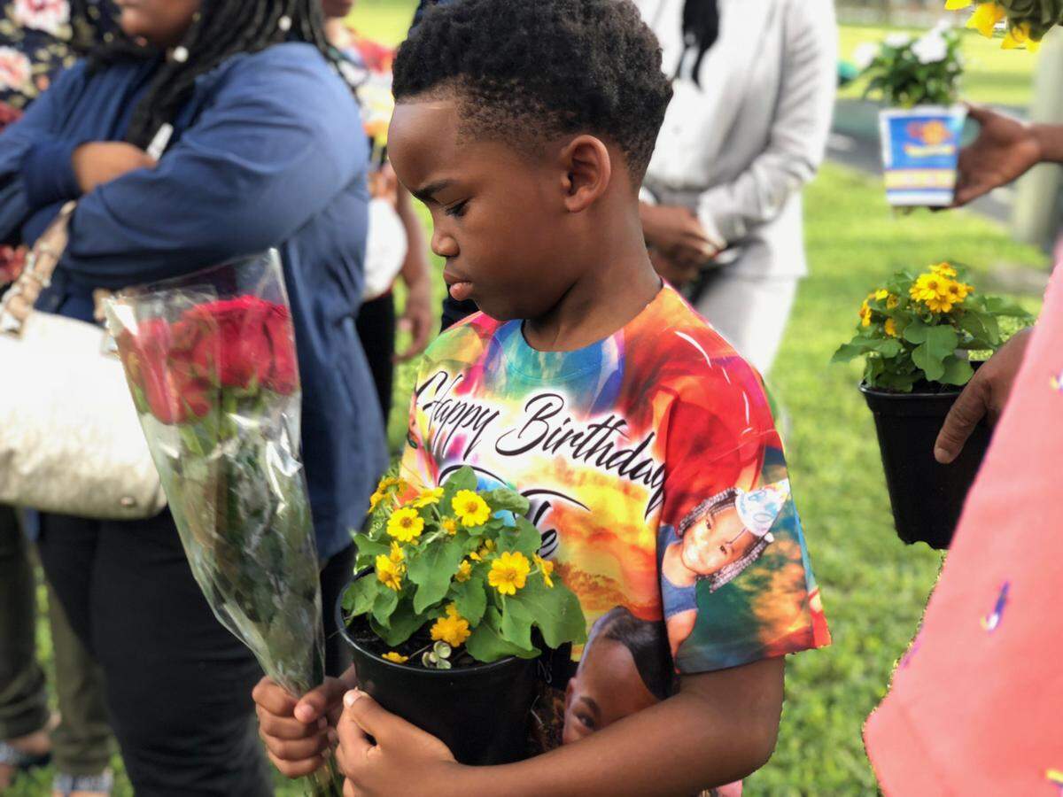 Gevarius Forshee, 8, carries flowers at a memorial for his sister, Tequila Forshee, who would have turned 18 on Sept. 24, 2018. She was killed in a shooting in 2013 in Miami Gardens when she was 12 years old.